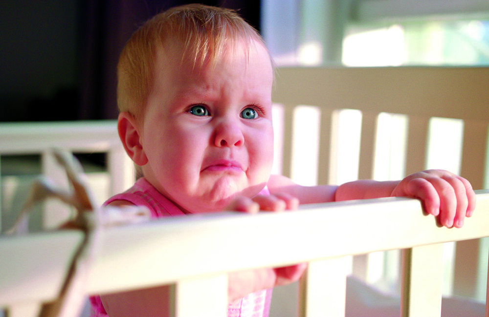 sad-baby-crying-cot-home-unhappy-toddler-standing-crib.jpg